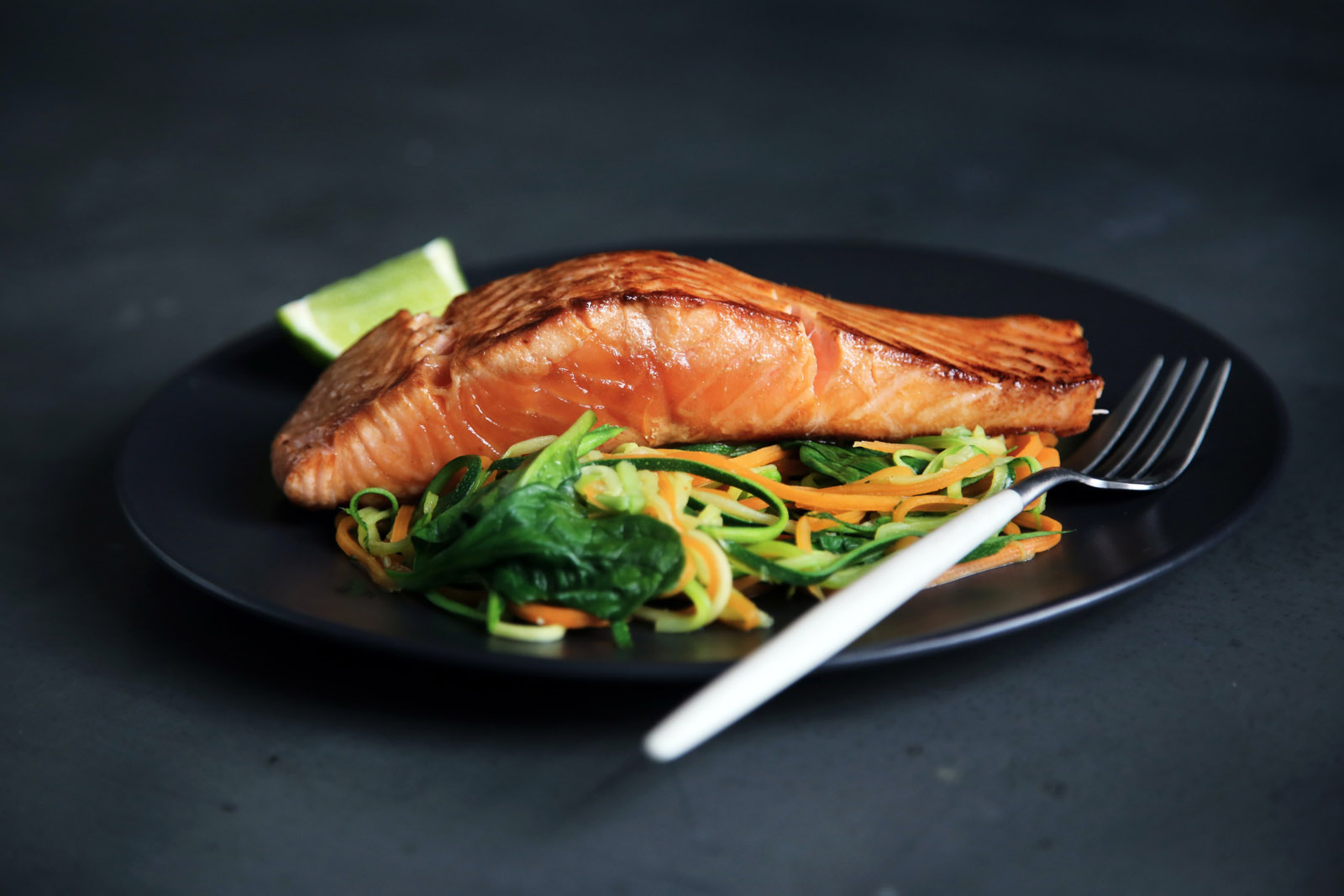 Plated salmon with salad dressing